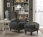 a grey upholstered wingback chair with buttons across the mid-back, styled in a grey and white room with a grey ottoman and grey floors what IS it with the grey floors?!