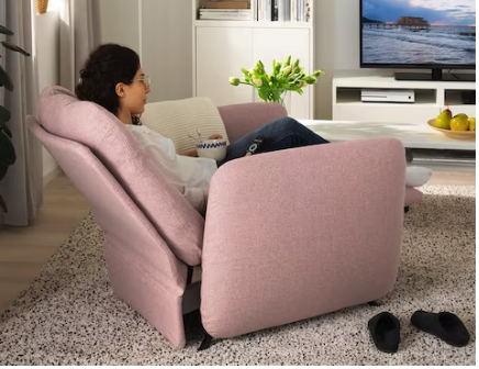 A curvy pink recliner with little metal feet it's sort of bubble looking and adorable 