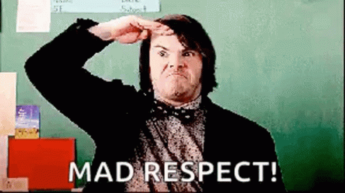 Jack Black giving a fierce salute gesture in front of a blackboard above the caption MAD RESPECT