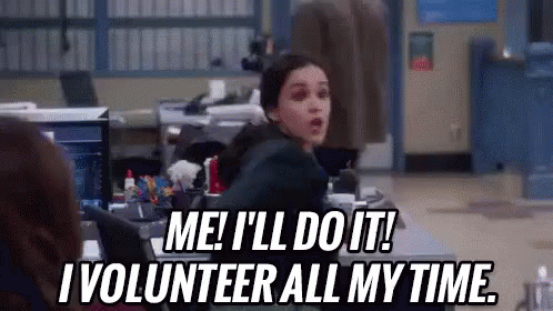 Melissa Fumero as Amy on Brooklyn 99 stands up and says Me! I'll do it! I volunteer all my time!