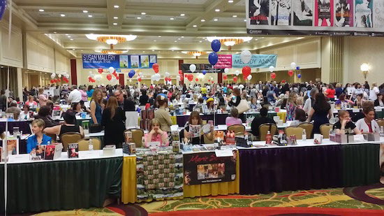 A wide shot of a very full ballroom of authors with banners for Susan Mallery and Jill Shalvis from the ceiling 
