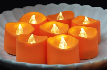 Orange battery operated tea lights with flickering bulbs 