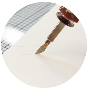 A close up of a heated craft knife cutting through foam like BUTTAH 