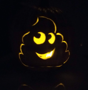 The smiley face pumpkin from the earlier photo is lit with a candle and..it's a smiling poop emoji. I had a lot of fun carving that one!