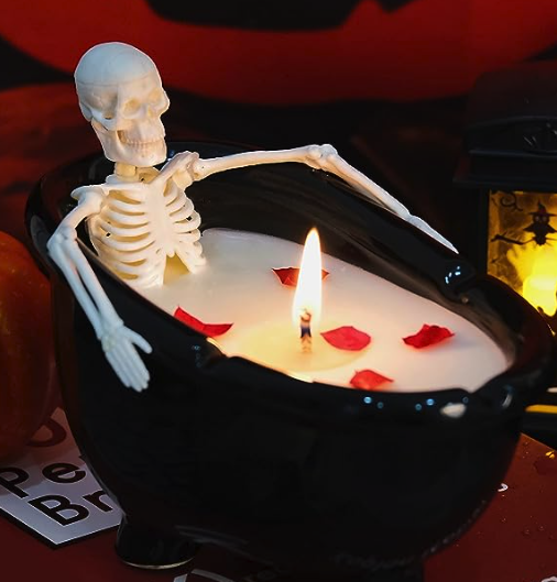 a candle of a skeleton in a black bathtub filled with white candlewax. The wick is...not really in a good place 