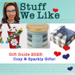 Stuff We Like gift guide 2023 Cozy and Sparkly Gifts - sparkly latte earrings, a blue nordic print candle, and a fuzzy fluffy blanket