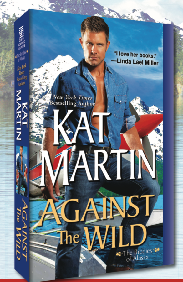 Kat Martin's Against the Wild features a man with a solemn face wearing a canadian tuxedo with a plane behind him with the nose angled so it's right in line with his crotch