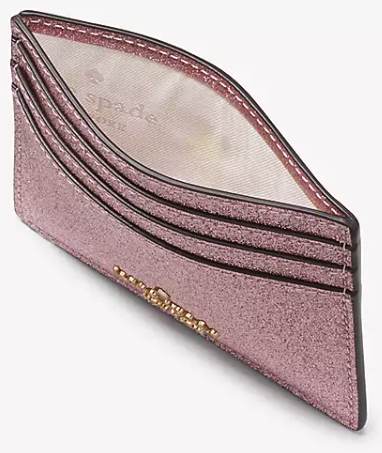 An overhead view of the wallet flexed open to show the fabric lining inside, and yeah, it kinda looks like a yoni