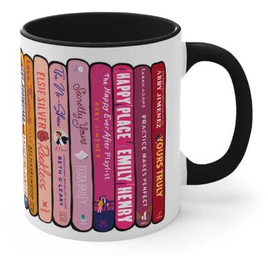 Another view of a bookstack mug this one with pink titles like Happy Place by Emily Henry, and the No Show by Beth O'Leary