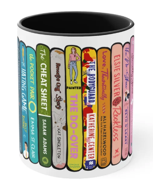 A picture of a mug with illustrated book spines ranaging from blue to pink including Red White and Royal Blue, The Cheat Sheet, the BodyGuard, Love Theoretically and other titles