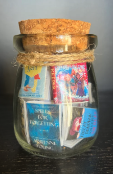 Small jar of books incluidng Weather Girl by Rachel Solomon and Lessons in Forgetting by adrienne young