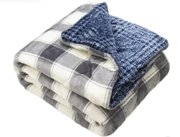 Printed velvet reversible throw blanket in grey and cream plaid on one side and a darker blue narrow plaid on the other side it is VERY fuzzy and in the picture is folded into a very plump square