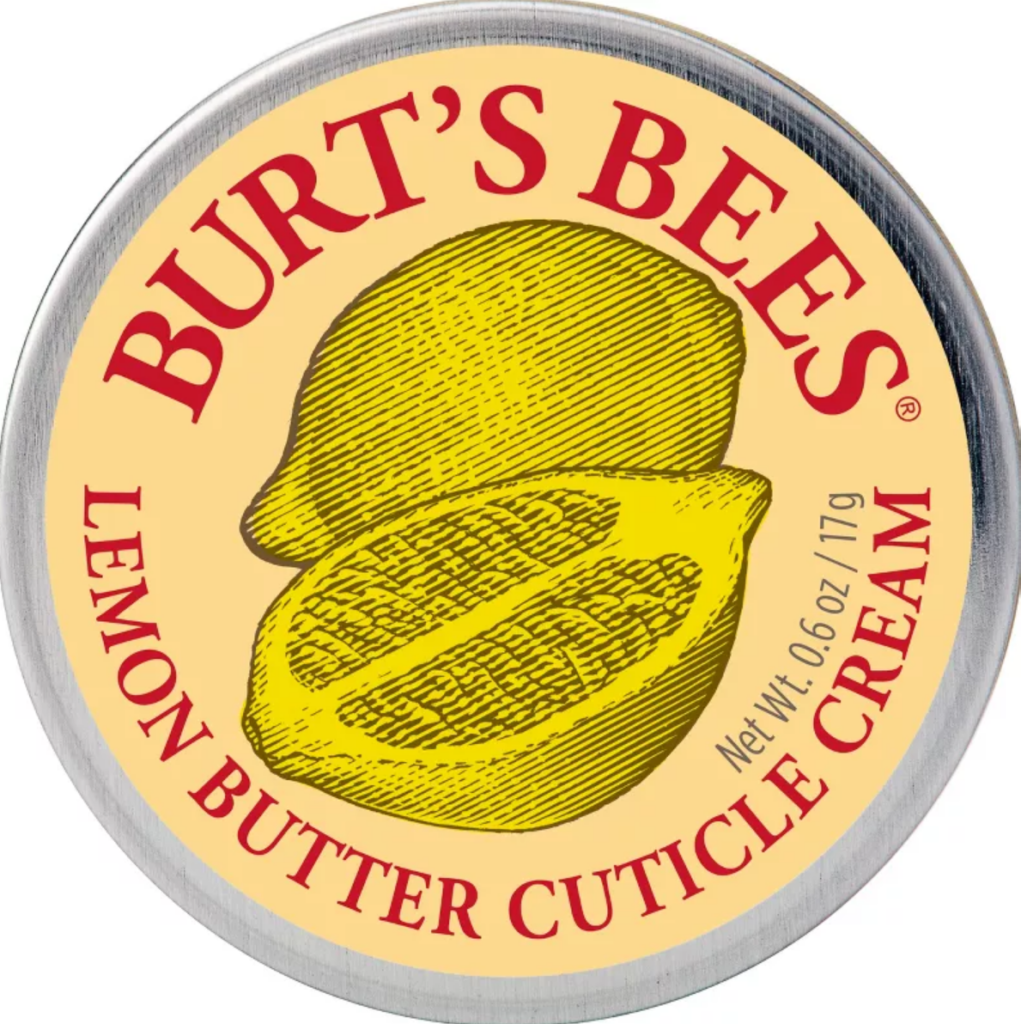 A round metal tin of cuticle cream. There's an illustration of lemons on the lid, as it's a lemon scent.