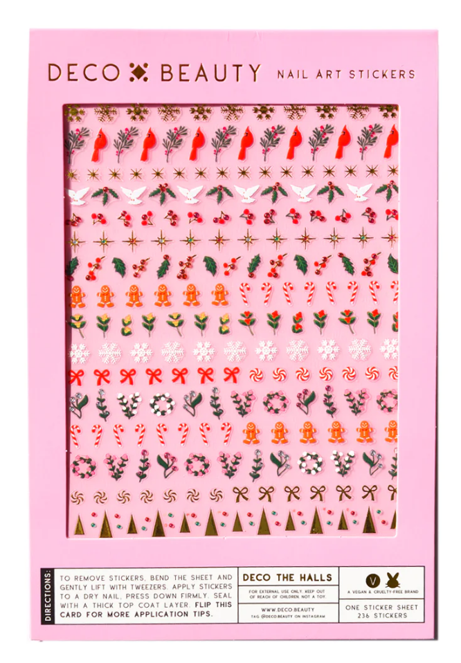A sheet of holiday themed nail stickers with images like bows, wreathes, and candy canes.
