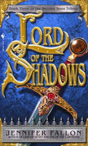 LORD of the SHADOWS is written in BIG GOLD letters with lots of filigree and decoration and behind them a hilt of a sword with red gems and lacquer. below a sharp metal fence image is the authors name Jennifer Fallon