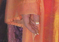 A close up of the very wide, white square french tips on the models hand on the cover