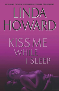 The cover for Linda HOwards KISS ME WHILE I SLEEP which, no thank you. The majority of the cover is purple with black letters for the author name and white for the title but at the bottom is a fuzzy horizontal image of a woman laying on top of a guy, and she's naked but her nipple has been photoshopped out? It's wild