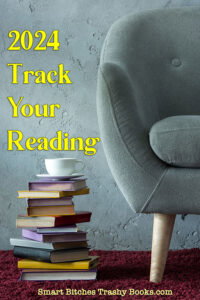 A sage green easy chair with rounded arms and back with pale wooden legs is on a dark carpet next to astack of hardcover books with a teacup on top. above the books it says 2024 Track Your Reading and at the bottom it says Smart Bitches Trashy Books in yellow print