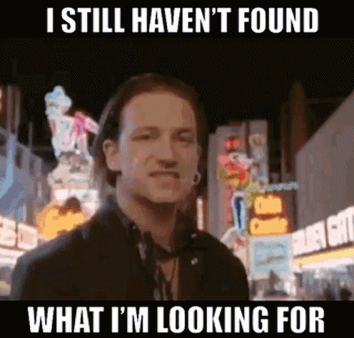 A still for U2's music video for "I Still Haven't Found What I'm Looking For" with lead singer Bono grimacing. The caption is "I still haven't found what I'm looking for."