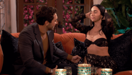 Maria sits next to Joey while wearing a revealing outfit.