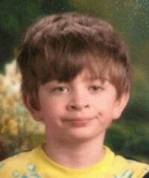 A small boy has a facial expression that suggests he's less than impressed