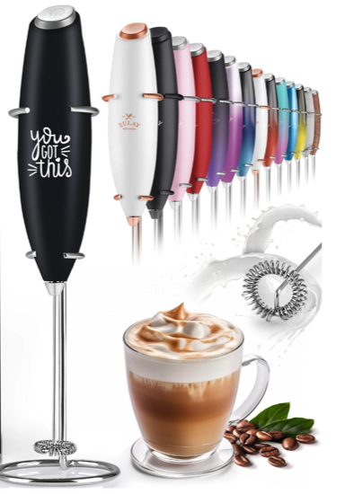 A hand held milk frother with a wire flat whisk at the bottom and a black handle that reads YOU GOT THIS alongside other handle color options in the lower right corner is a cappuccino and some coffee beans 