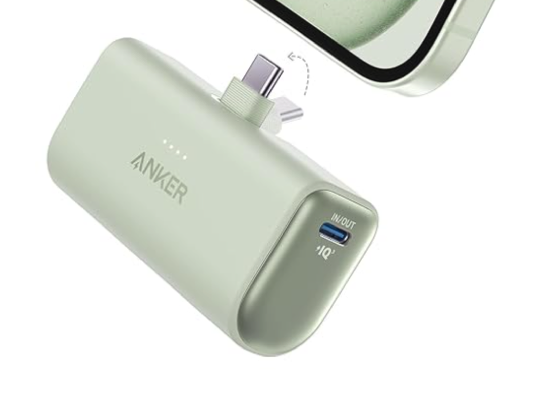 Green Anker portable battery with a flip up USB C connector and the bottom edge of a phone 