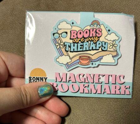 A magnetic bookmark that says books are my therapy
