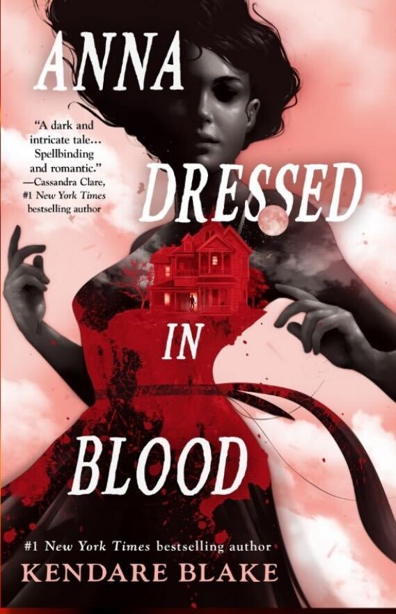 Anna Dressed in Blood by Kendare Blake. The background is cotton candy pink clouds. A woman in black and white is wearing a red dress. It looks like she's reeling back from something. In the dark red of her dress is the outline of a mansion.