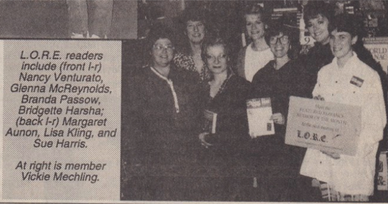 A group photo of the members of LORE standing together and smiling for the camera. The caption reads LO.R.E. readers include (front 1-r) Nancy Venturato, Glenna McReynolds, Branda Passow, Bridgette Harsha; (back I-r) Margaret Aunon, Lisa Kling, and Sue Harris. At right is member Vickie Mechling.