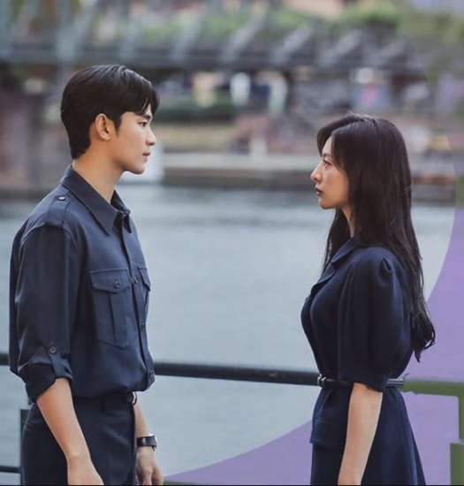 Poster for Queen of Tears with characters facing each other on a bridge. She is wearing a dress while he has a dark shirt on with his sleeves rolled up