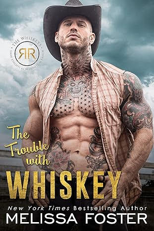 The Trouble with Whiskey by Melissa Foster. A man in an unbuttoned, sleeveless plaid shirt is standing by a body of water with a cloudy sky. He has a cowboy hat on and is covered in tattoos, most notable what appears to be a quilted star pattern across his pecs.