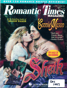 The December 1997 cover for Romantic Times featuring the stepback cover for SHEIK by Connie Mason, featuring a blonde White woman with frizzy hair and a belly dancer belt on her forehead kissing a guy with long dark hair and some kind of massive necklace with beads and a big ornament against a very drapey backdrop it is extremely 90s