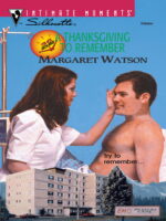 A White brown haired woman reaches out and touches the forehead of a shirtless hairy white man who looks baffled and they're giants on top of a hospital.