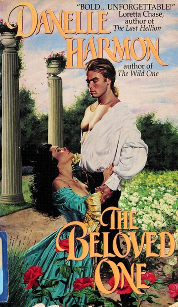The Beloved One - a White guy with his shirt open and a pony tail and his shirt tucked in and unbuttoned with massive sleeves and a woman with giant masses of black hair kneeling at his feet in an off the shoulder dress, with columns. GIANT ERECT COLUMNS behind them both.