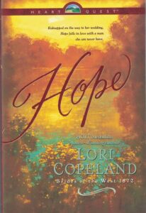 HOPE - a soft focus image of a sunset over a lake with gold red and green 