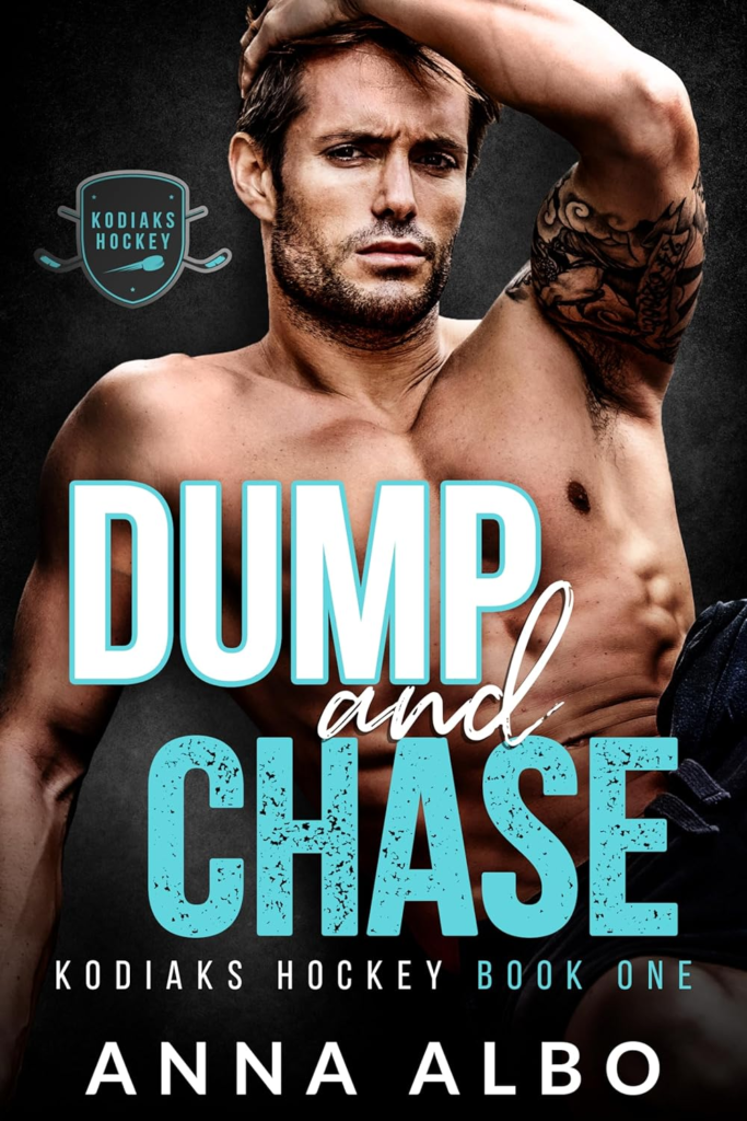 Dump and Chase by Anna Albo. A shirtless  man that is sitting down. He is leaning back on one hand and this other hand is running through his brown hair. The way he is flexing makes his chest flair and bulge out.