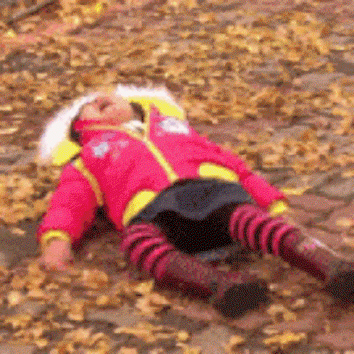 a little girl lays on the ground and kicks her feet having a tantrum
