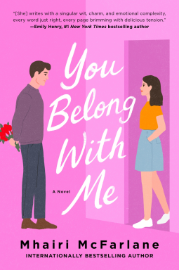 You Belong With Me - Mhairi McFarlane - a pink background with a dark haired woman in blue shirt and orange shirt walking through te door facing a man holding flowers behind his back 