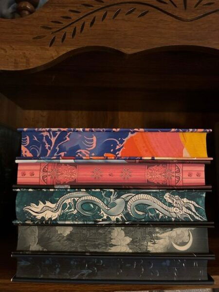 A stack of five books with the sprayed edges displayed.