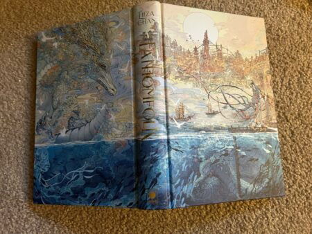 A mythical landscape above and below water that spans the front and back of the book.