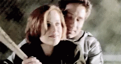 Mulder standing behind Scully showing her how to swing a bat. They are VERY close