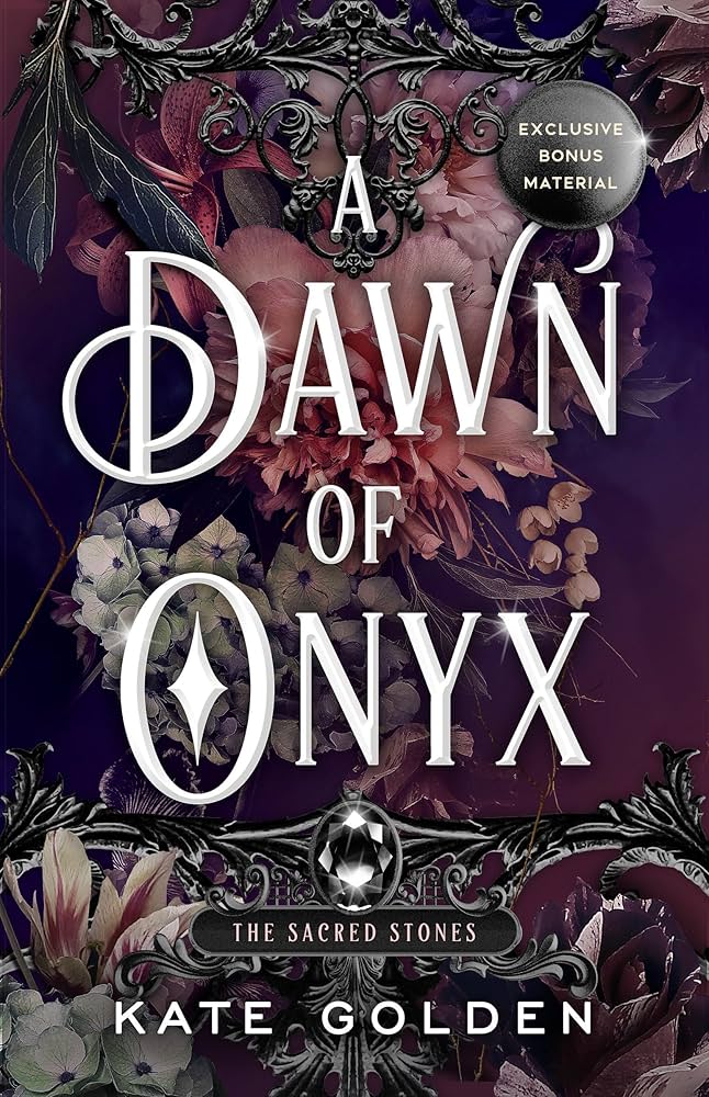 A Dawn of Onyx by Kate Golden. A dark burgundy backgroudn with muted white and pink florals. Dark iron filigree decorates the top and bottom of the cover with a dark, shining oval jewel on the bottom.