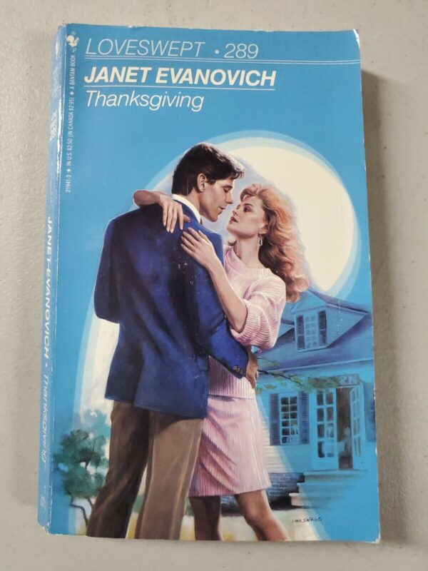 Loveswept - Thanksgiving by Janet Evanovich. A blonde white woman in a pink dress is dancing? With a white guy with dark hair and a blue jacket and chinos 