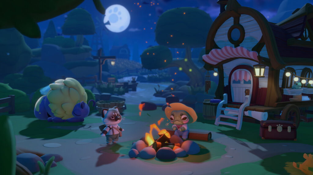 A little gray and black cat in overalls sits around a fire with a frog in a straw hat. A caravan is positioned behind them with a full moon in the sky.
