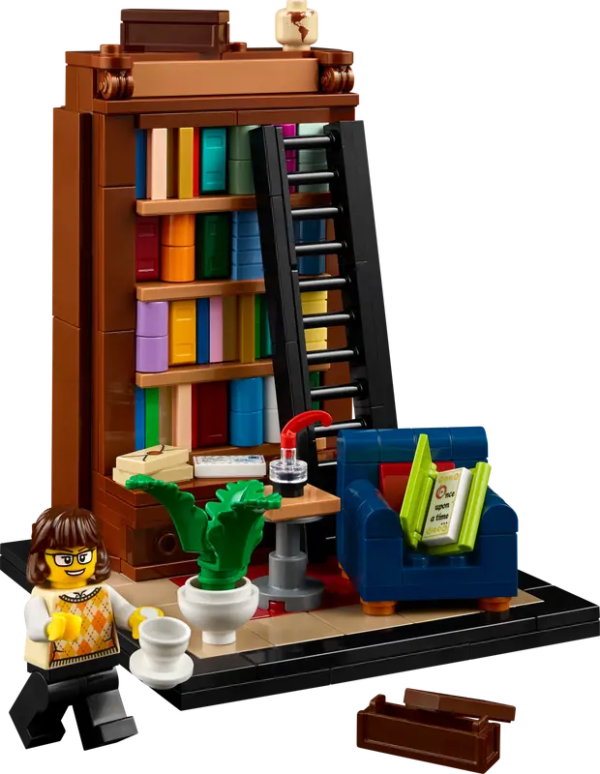 The minifig has a cup of tea and on the blue chair behind you can see the first page of the book is Once Upon a Time 