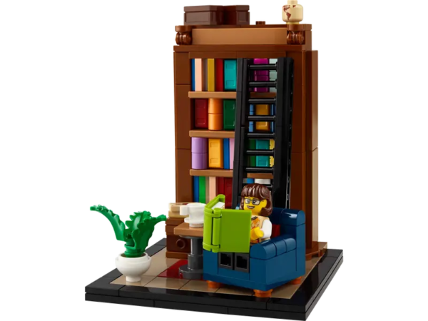 Books are my Passion; a little brown haired minifigure in glasses is seated in a tiny library with a bookcase