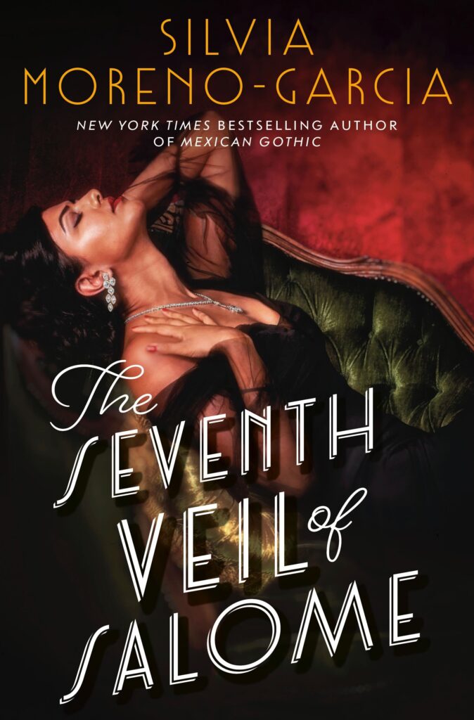 The Seventh Veil of Salone by Silvia Moreno-Garcia. A woman with light tan skin and dark hair pulled away from her face is stretched out on a couch. She is leaning back with a hand resting near her throat. She is wearing  a gauzy off the shoulder black dress and has diamonds dripping from her ears and neck. The wallpaper is a deep red. 