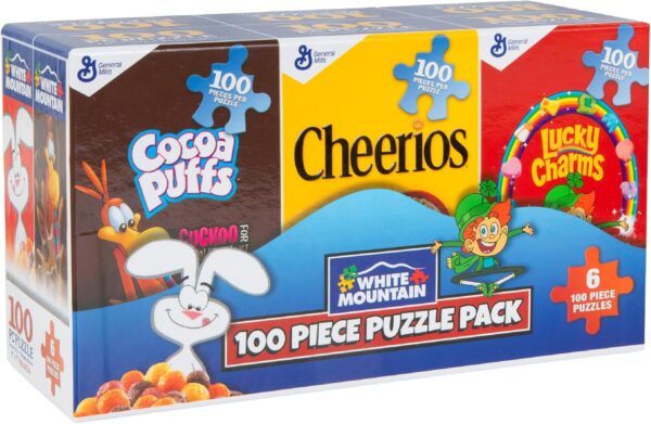 A box of miniature cereal boxes that are actually 100pc puzzles - visible are cocoa puffs, cheerios, and lucky charms 