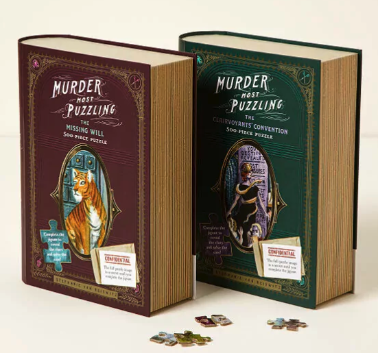 Two books that are boxes for murder mystery puzzles. One is burgundy and one is green. Both are labeled Murder Most Puzzling. 